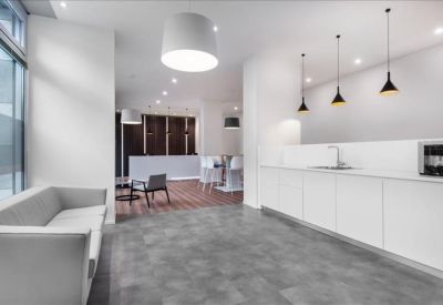 Contemporary break area with a white kitchen island and stylish pendant lighting.