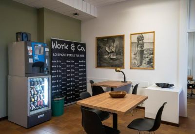 Communal area with snack machine and wooden tables.