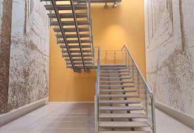 Private office space featuring a white L-shaped desk and blue ergonomic chairs by a large window.