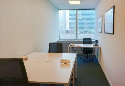 Private office suite with desks, ergonomic chairs, and large windows.