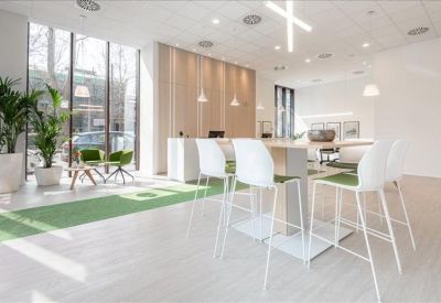 Bright lobby area with white bar-style seating and a green carpet runner.