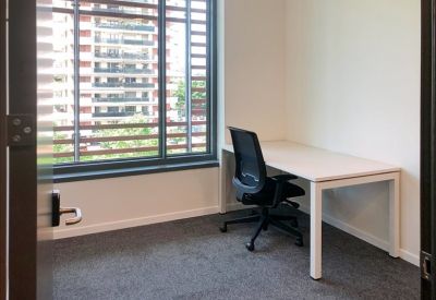 Private office with a single desk and ergonomic chair by the window.