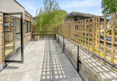 Private outdoor terrace with paved flooring and timber trellis fencing.