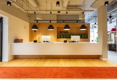 Sleek white reception desk with modern black pendant lighting.