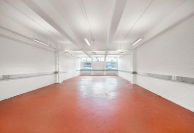 Large industrial-style workspace featuring a polished terracotta-colored floor.