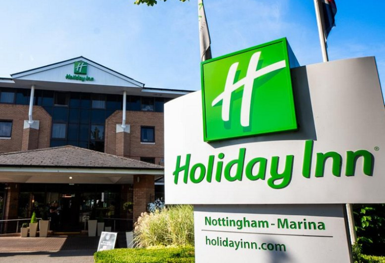 Exterior of the Holiday Inn Nottingham - Marina building featuring a large green sign and brick facade.