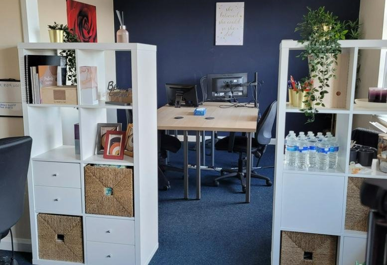 Open-plan workspace at Kirkfields Business Centre, Office 5 & 7, with white shelving and a blue feature wall.