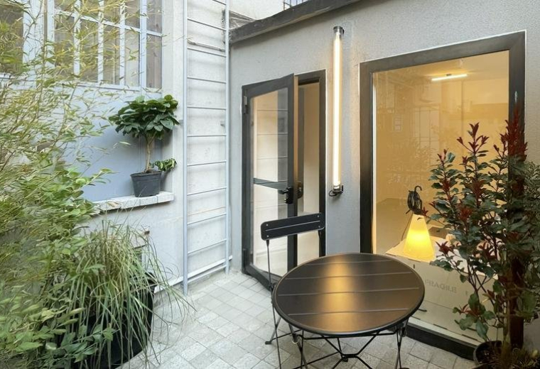 Spacious outdoor courtyard with lush greenery and patio furniture at 126, Via Nicola Antonio Porpora.