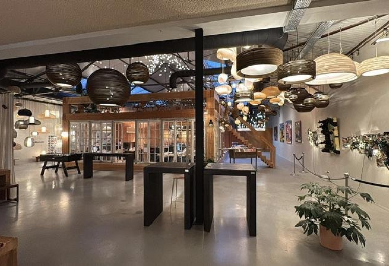 Large open-plan common area with a variety of decorative hanging lamps.