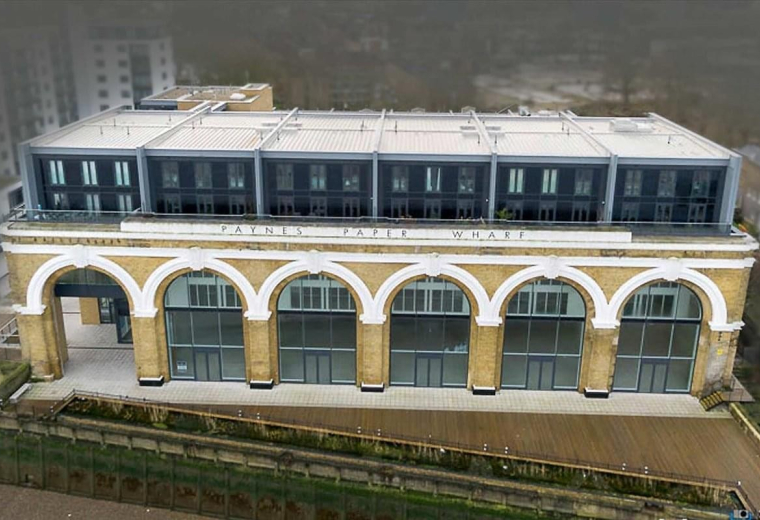 Exterior view of the historic arched facade and modern upper levels at 23 Wharf Street, Greenwich.