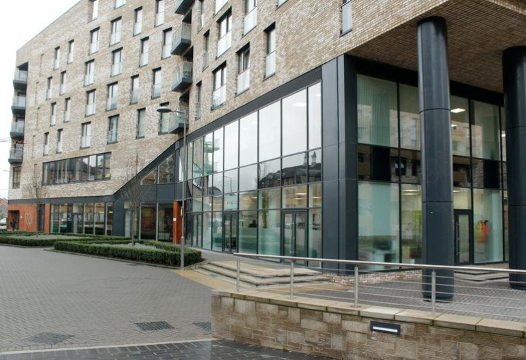 Exterior view of the modern brick facade and glass entrance at Cadmus Court, Plough Way.