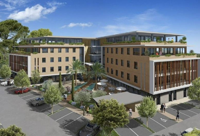 Exterior view of the modern Aix-TGV business center with landscaped courtyard and parking.