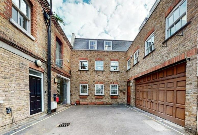 Exterior view of the brick facade and courtyard at 10, London Mews.