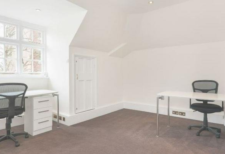 Spacious two-person office suite at 105 Sumatra road with white desks and natural light from a bay window.
