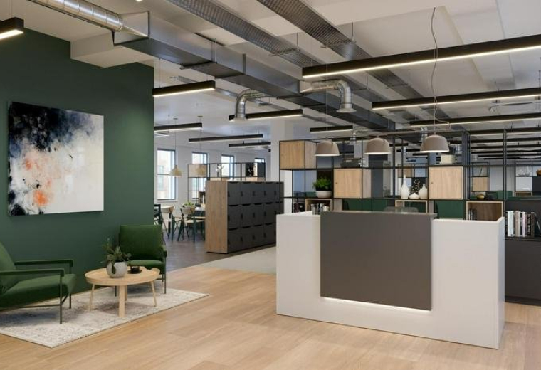 Modern reception area with a green feature wall and soft seating at 107 Grays Inn Road, London.
