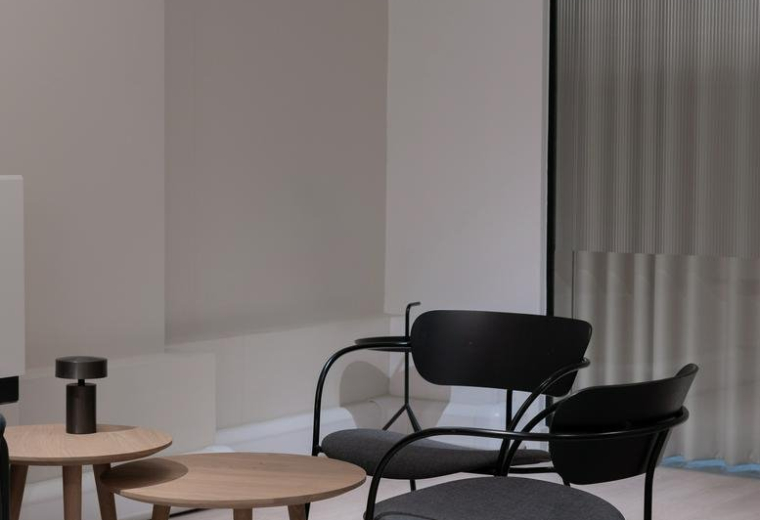 Modern lounge area with round paper lantern and designer chairs.