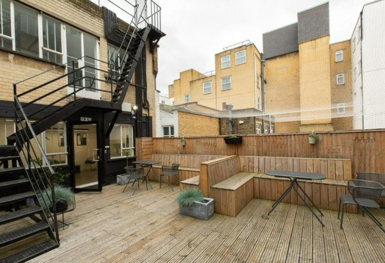 Spacious wooden roof terrace with seating at 12 David Mews, Marylebone.