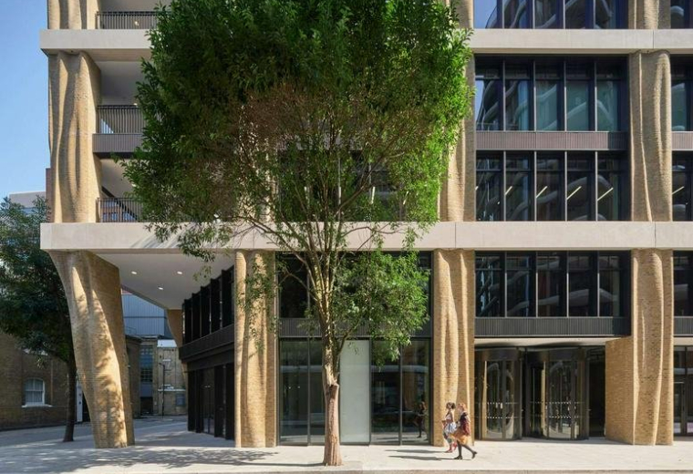 Exterior view of the contemporary facade at 135 Park Street London with tree-lined entrance.