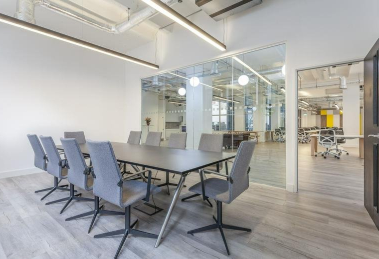 Meeting room at 17 Bevis Marks, London, EC3A with a large grey table and ergonomic chairs.