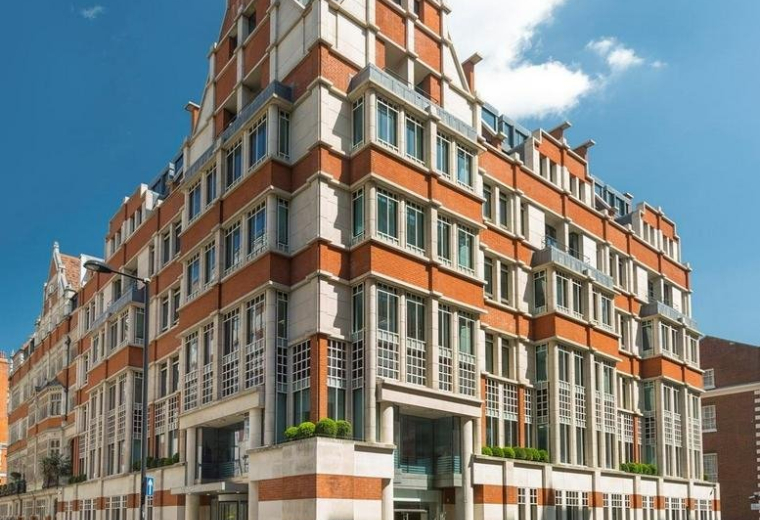 Exterior view of the red brick and stone facade of 2 Park Street, Central London, W1K.