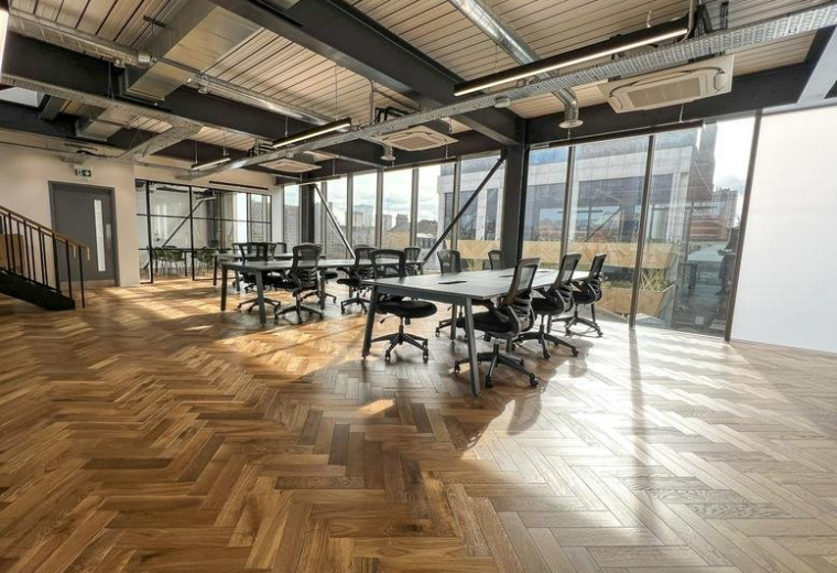 Spacious sunlit open-plan office with parquet floors and modern workstations at 25 Settles Street.
