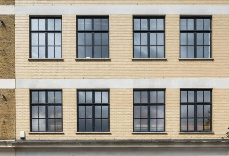 Exterior view of the brick-facade building at 25, West Tenter Street, London.