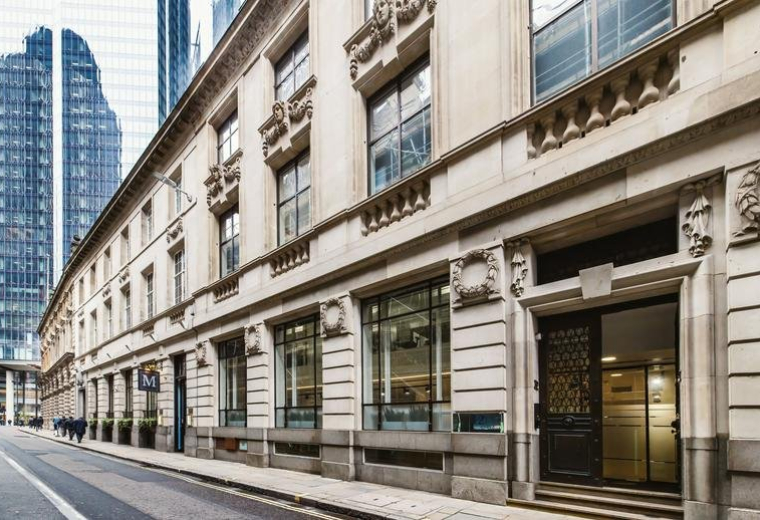 Exterior view of the historic stone facade and entrance of 32 Threadneedle Street.