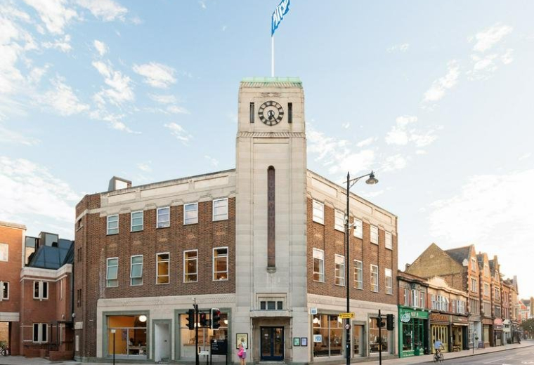 Exterior view of the historic brick and stone Electricity Board Building with a prominent clock tower.