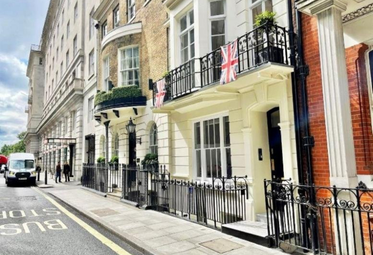 Exterior of the traditional brick and white stone building at 7 Stratton Street, London.