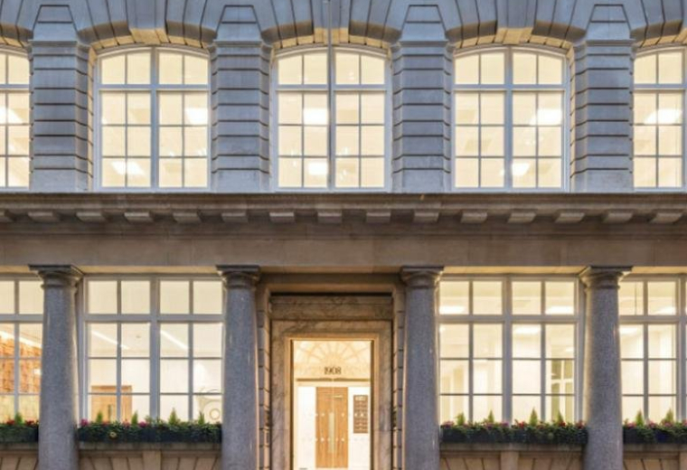 Grand stone facade and columned entrance of the 8, Lloyd’s Avenue building.