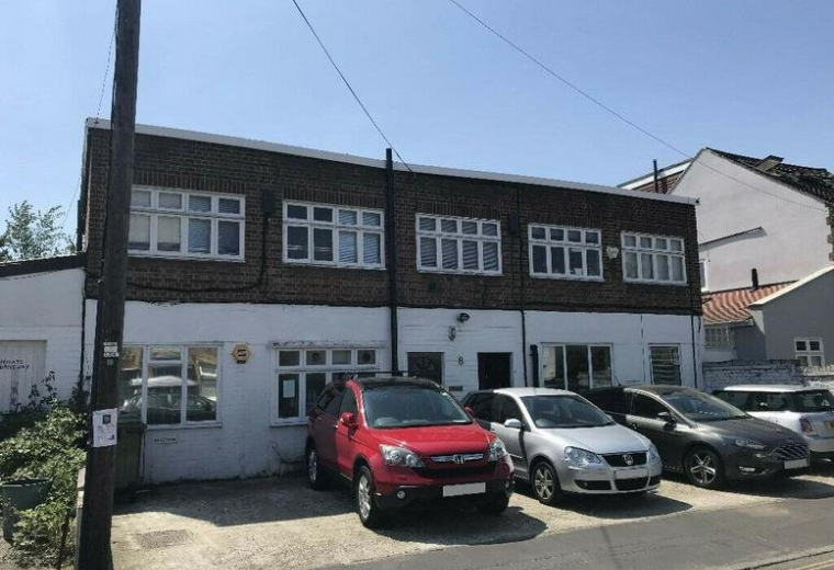 Exterior view of the brick and white facade at 8 Second Cross Road, Twickenham.