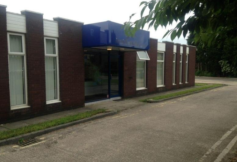 Exterior view of the brick facade and blue entrance canopy at Archbold House, Albert Road, Morley.