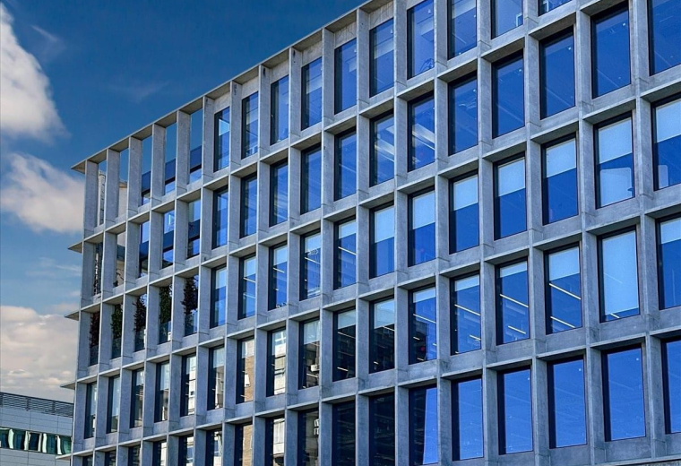 Exterior view of the modern grid facade at Avenida de Manoteras 12, Madrid.