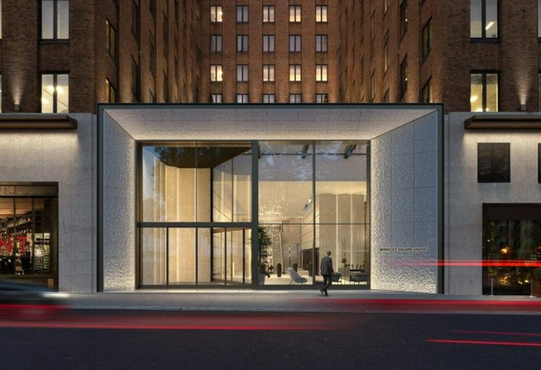 Modern glass storefront entrance of Berkeley Square House, London at dusk.