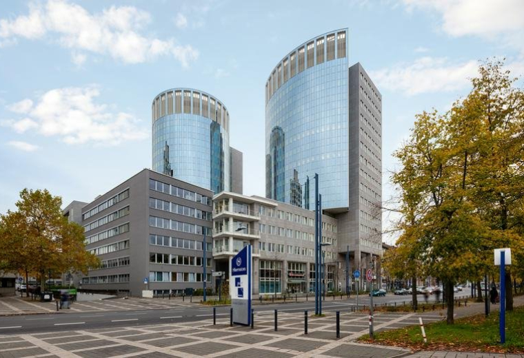 Exterior view of the modern twin glass-tower building at Berliner Straße 114-116.