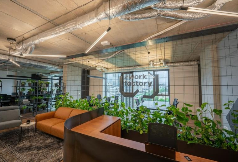 Spacious reception area with leather sofas, lush greenery, and modern lighting at 1 Atanas Dukov Str. floor 6.