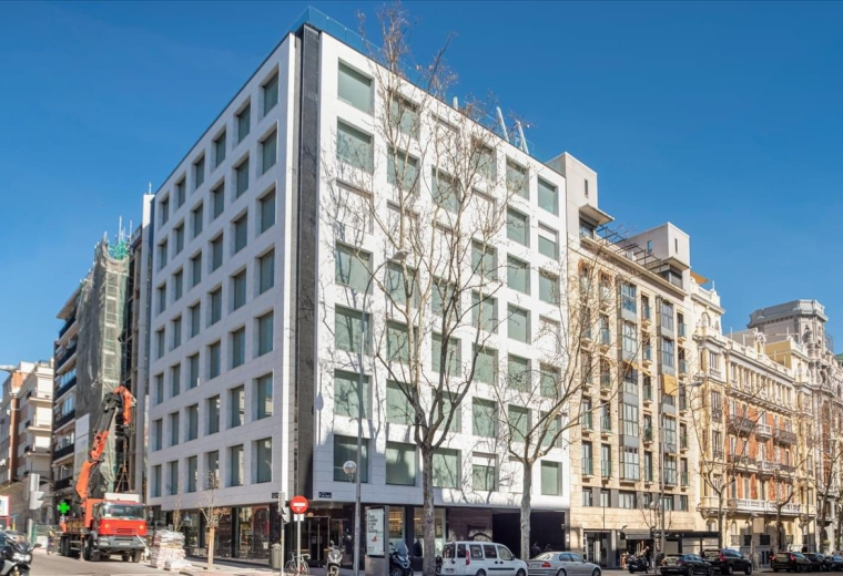 Exterior view of the white modern facade and classic architecture at Jose Abascal 41, Madrid.