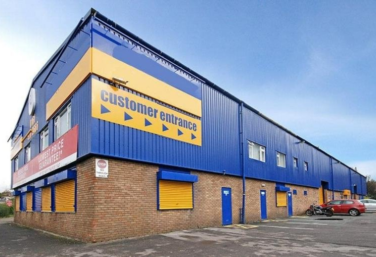 Exterior view of the blue and yellow building at 189 Manchester Road, Oldham, Lancashire.