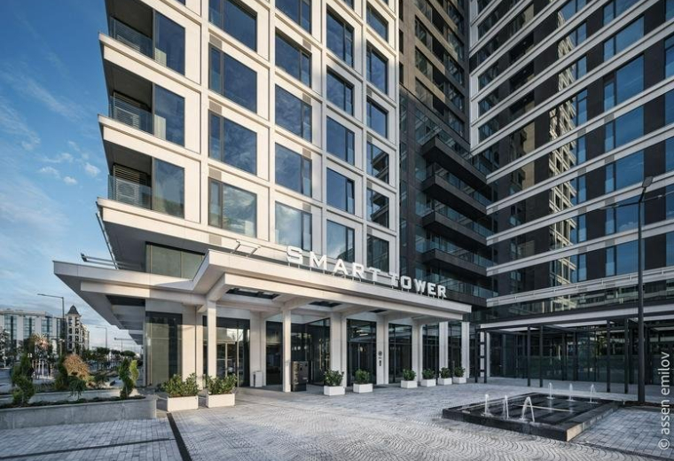 Exterior entrance of Smart Tower with a modern canopy and paved forecourt.