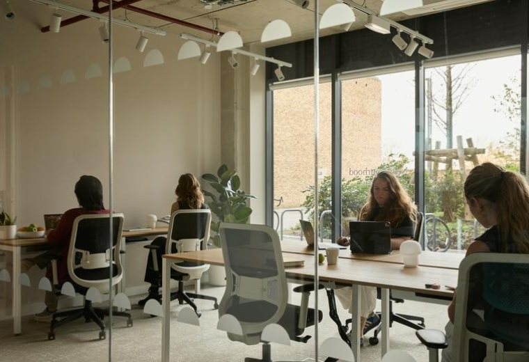 Spacious coworking area with individual desks and large windows at 3, Watermead Way.
