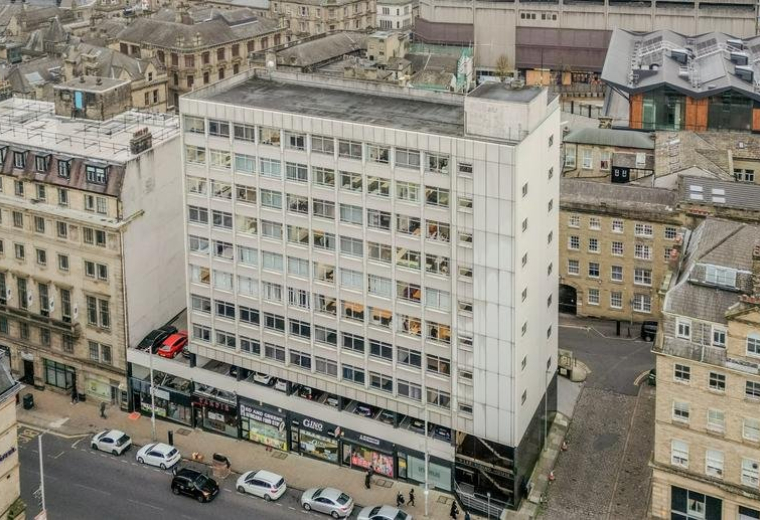 Aerial exterior view of the multi-story West Riding House building and surrounding city streets.