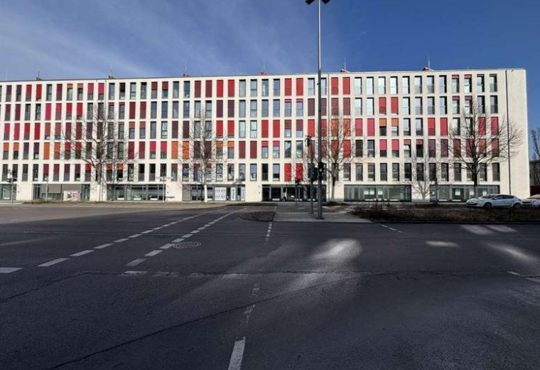 Exterior view of the modern white and red facade at 34B, Rudower Chaussee.