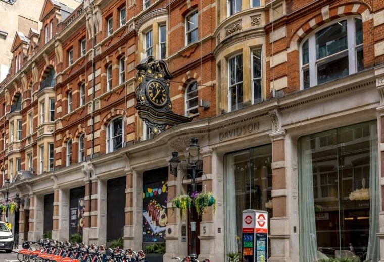 Ornate brick exterior facade of the building at 5, Southampton Street featuring a prominent hanging clock.