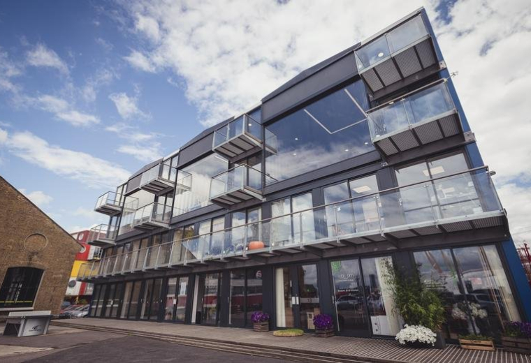 Exterior view of the modern glass-fronted office building at 64, Orchard Place, Trinity Buoy Wharf.