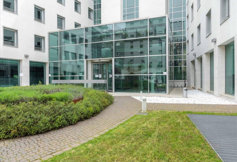 Modern communal lounge at 8/10 Via Roberto Lepetit, Milan, Italy with plush seating and industrial ceilings.