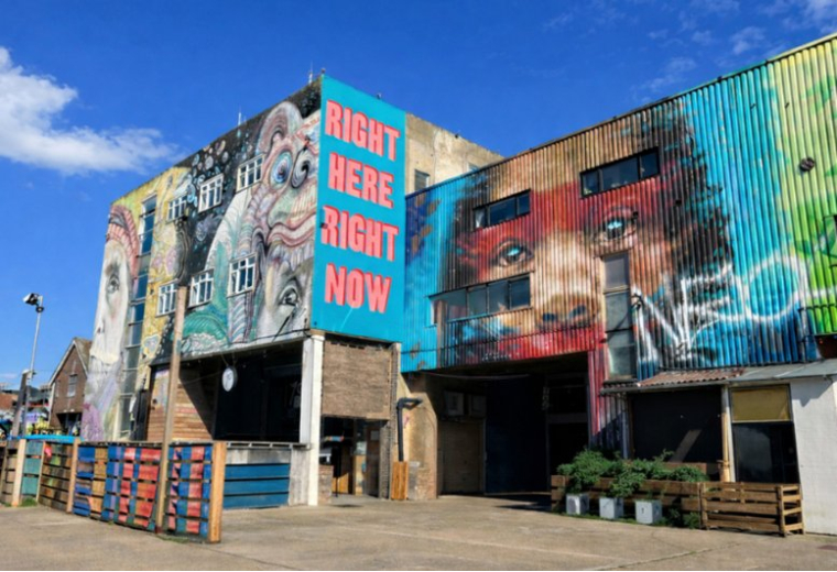 Exterior view of the colorful mural-covered building at 92, Wallis Road, 80, 90, 92-94 Wallis Road.