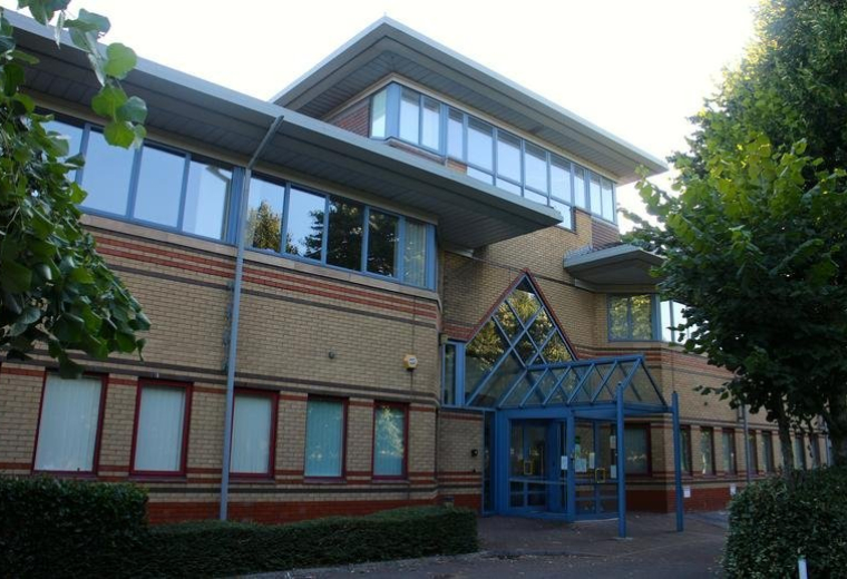 Exterior brick facade of Alexandra Gate featuring multiple levels and large windows.
