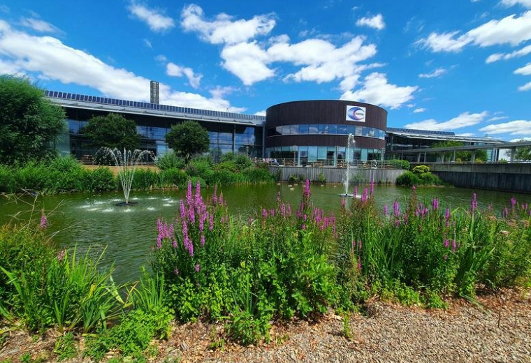 Exterior view of the CEME Campus, Launchpad & Innovation Centre with its modern facade and garden pond.