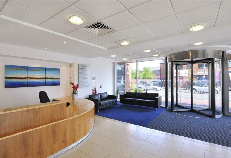 Modern lobby and wooden reception desk at Crossgate House, Cross Street, Manchester.