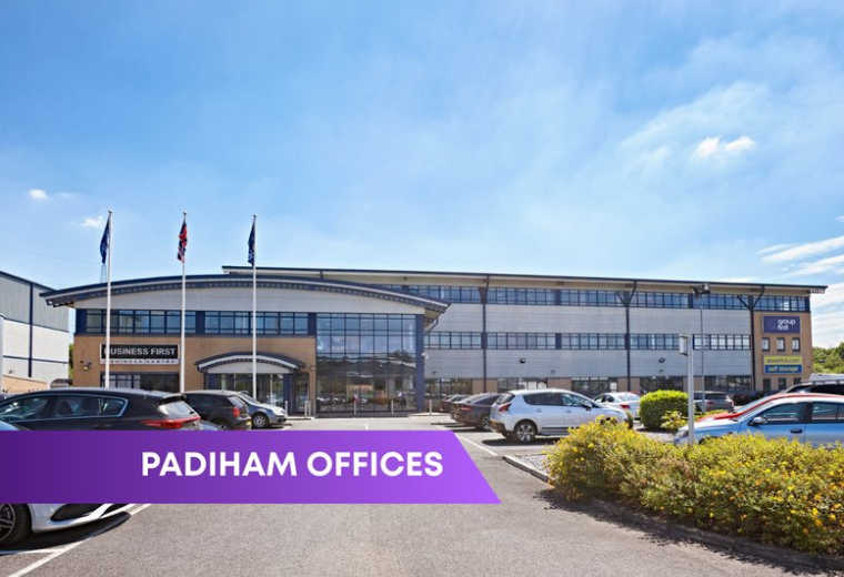 Exterior view of the multi-story Group First House building with a large parking lot.